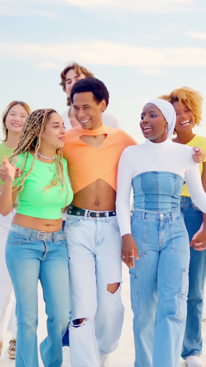 Happy multi-ethnic friends walking together along a promenade