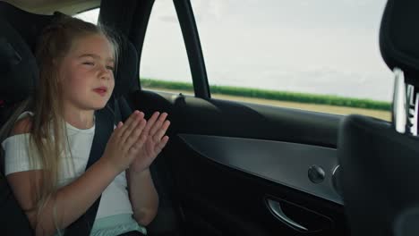 Niña-Caucásica-Cantando-Y-Aplaudiendo-Mientras-Conduce-El-Coche.