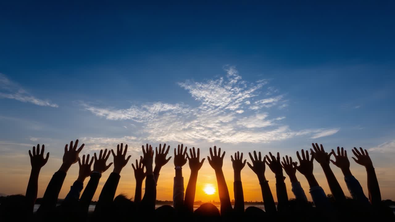 Celebrating Unity and Hope: A Silhouette of Raised Hands Against a Vibrant Sunset Sky, Symbolizing Togetherness, Joy, and Community Spirit in a Transformative Moment