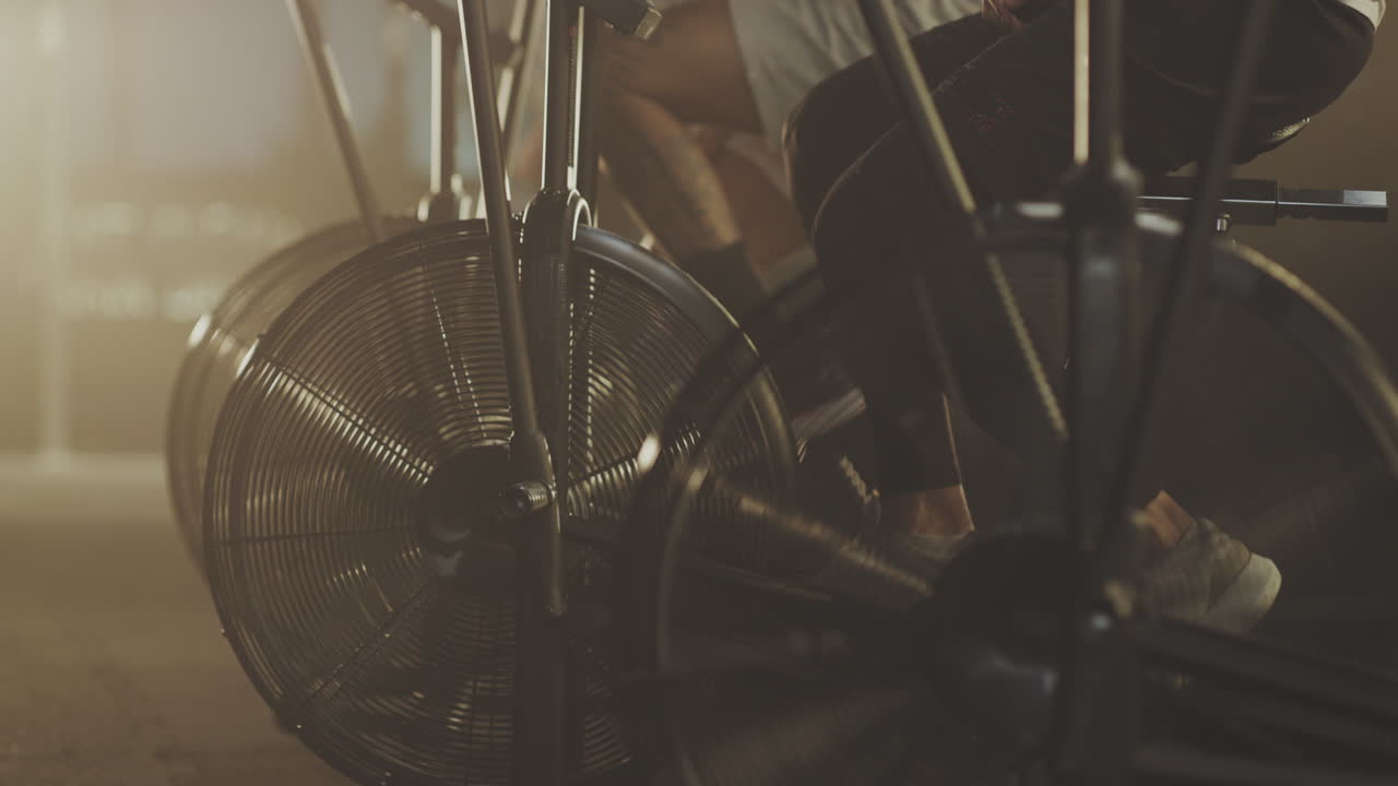 People Exercising on Air Bikes in a Gym