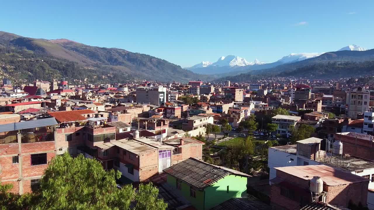 Person Drinking Coffee On The Balcony Overlooking The Residential Houses In Huaraz City In Peru. - aerial