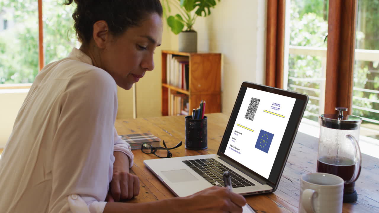 Woman working at desk, covid vaccination certificate with qr code and eu flag on laptop screen