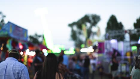 crowds enjoying rides and attractions at dusk