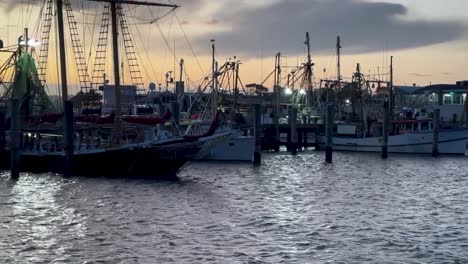 Docked-fishing-boats-at-wharf-marina,-Mooloolaba,-with-sunset-in-the-background