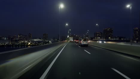 city lights ahead: tokyo highway at night witness tokyo’s sprawling new territories on a nighttime drive, with bright highway lights leading the way
