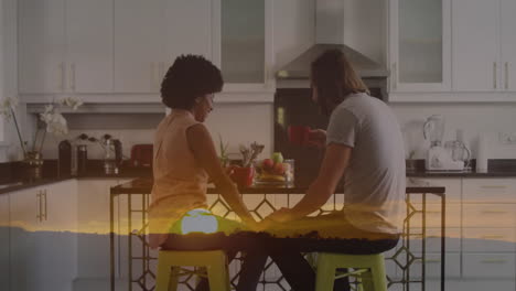 couple sharing breakfast at bright kitchen island, with animated red bowl icon and health chart