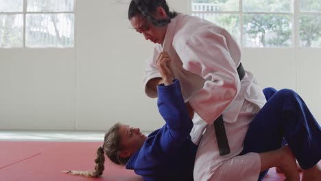 judokas fighting and immobilizing on the ground