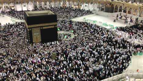 muslim pilgrims circumambulating and pray facing the kaaba