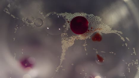 macro abstract red and clear bubbles moving together textured background