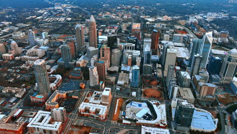 flying high above the city downtown at sunset. top view of charlotte, north carolina, usa