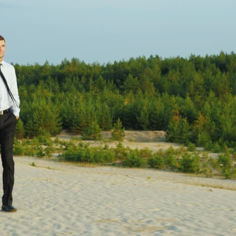 A-businessman-with-a-case-in-his-hand-walks-along-a-sandy-beach-2