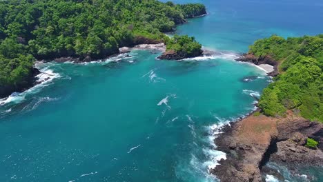 Stationary-Hover-of-Rocky-Coastline-with-Beach-Cove