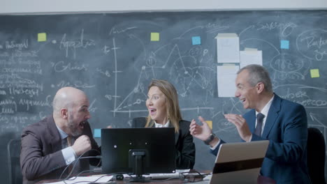 business partners sitting at table in boardroom