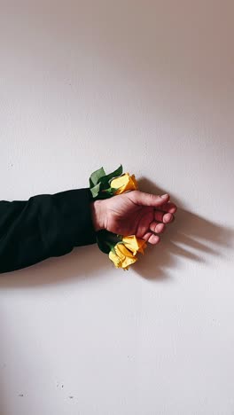 hand with yellow roses