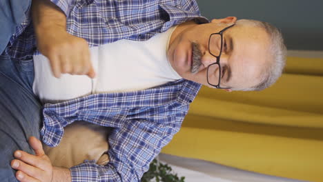 Vertical-video-of-The-old-man-is-biting-his-nails.