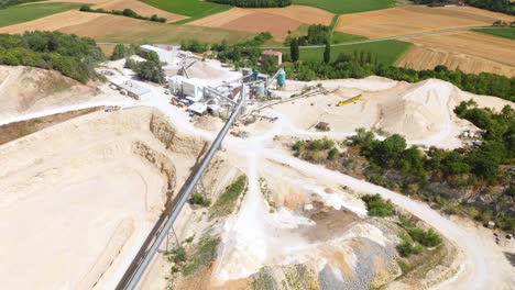 Conveyor-Belt-Of-Heavy-Machinery-For-Stones-And-Gravel-In-Limestone-Quarry---aerial-drone-shot