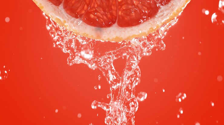 Grapefruit Slice Splashed With Water In Slow Motion And Macro On Pink Background
