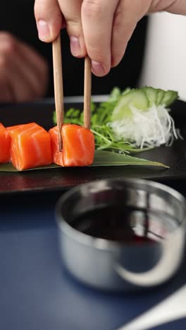 salmon sashimi with chopsticks