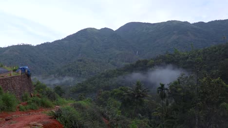 mountain covered with green forests and cloudy sky at morning video taken at vagamon kerala india.