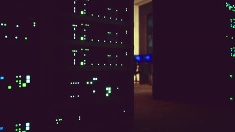 Data servers illuminated in a dimly lit office environment at night