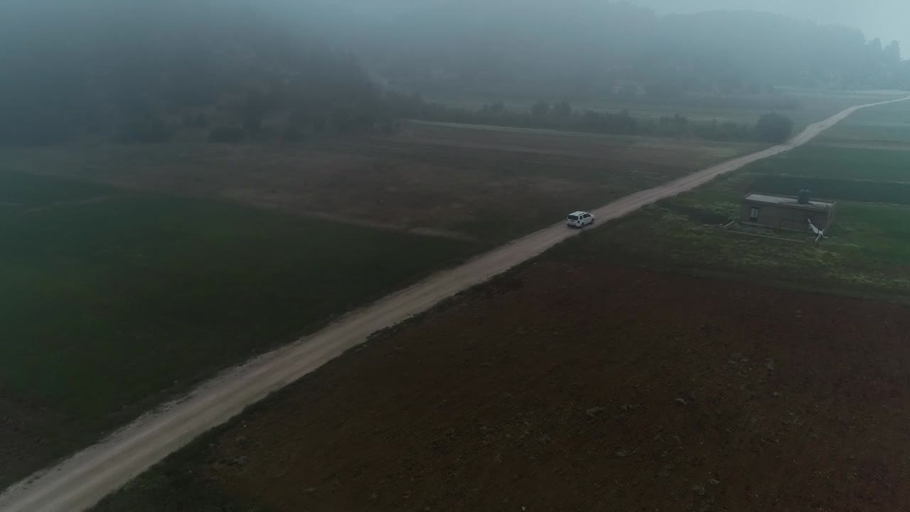 Foggy Countryside Road: A Serene Aerial View