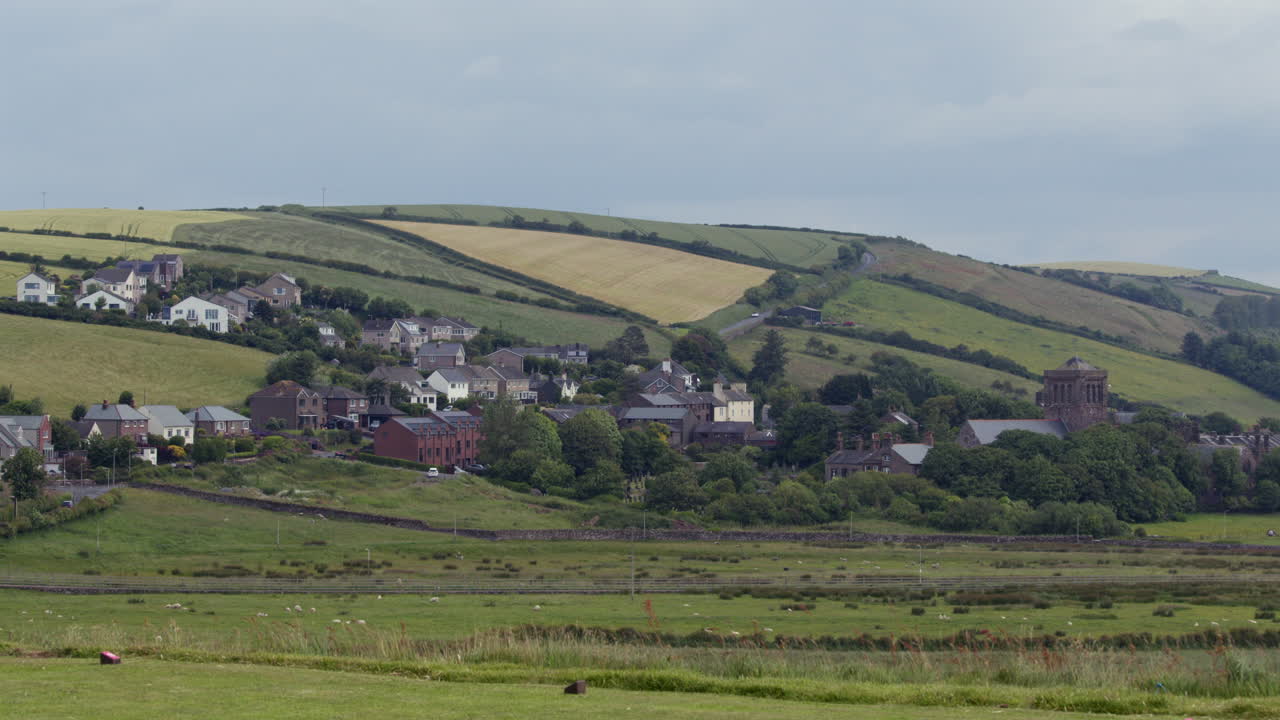 wide shot of the village of st bees, with hills in background. West lake district