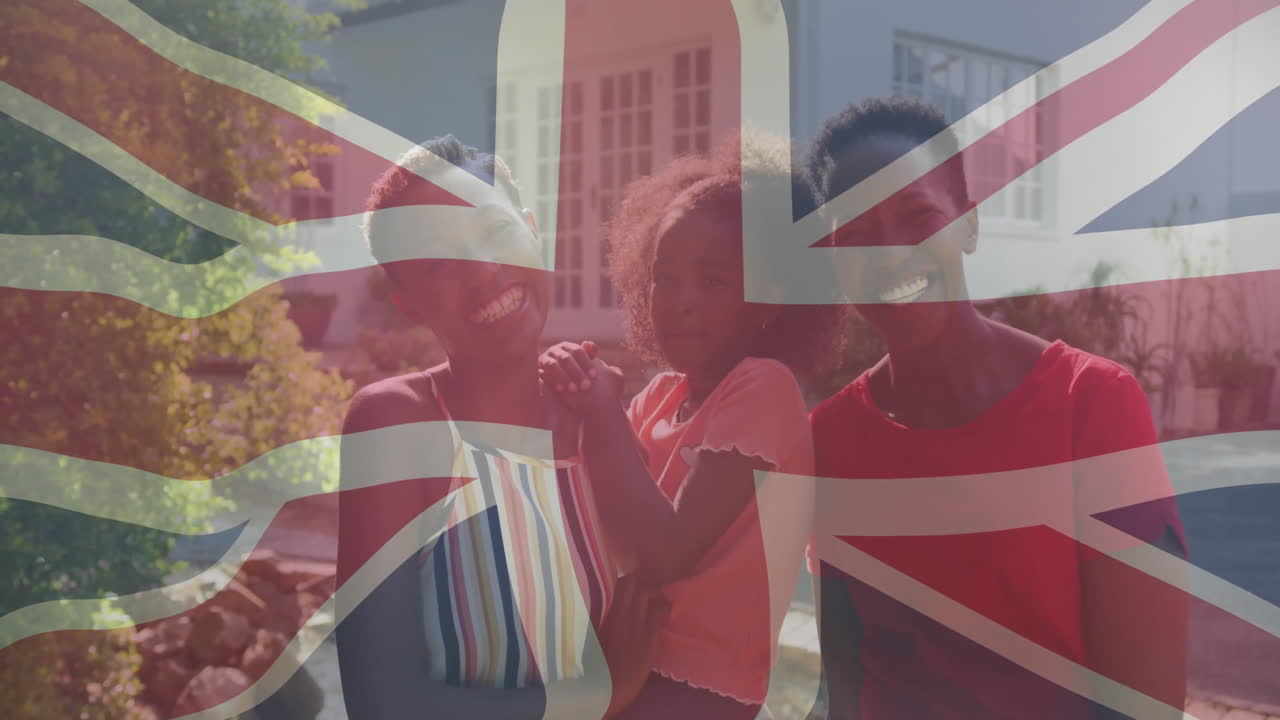 Holding Union Jack flag, family smiling outdoors with animation overlay