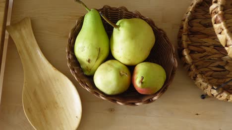 pears in a basket on a wooden table