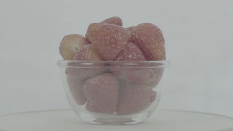 fresh, ripe, red strawberries in rotating bowl, ungraded