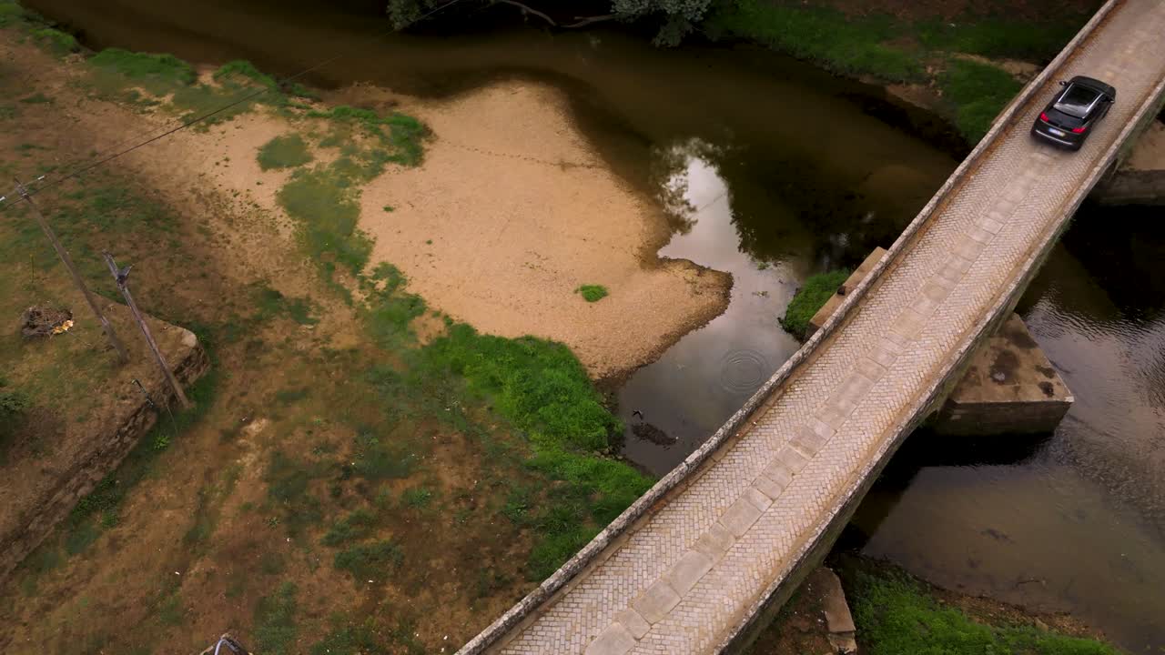 Romanesque bridge over serene river in Portugal, peaceful scenery