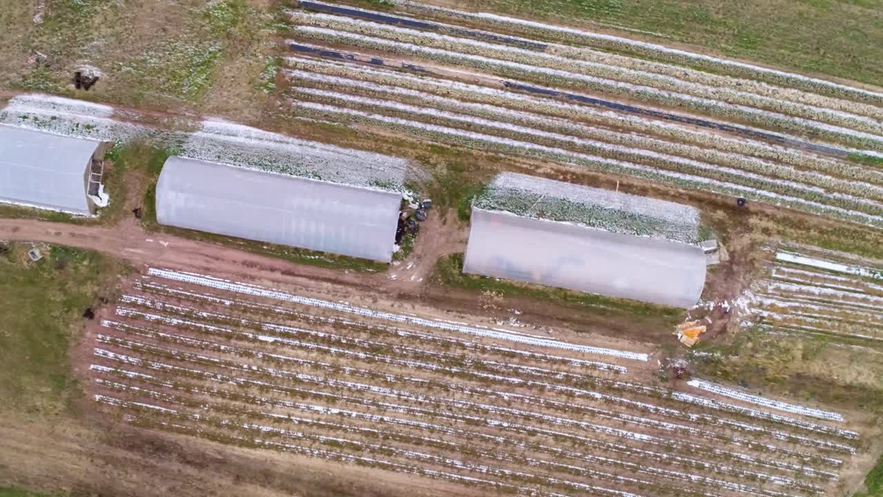 Aerial view of greenhouses and fields