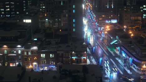 Montreal-downtown-city-residential-and-commercial-buildings-and-traffic-at-night-during-winter