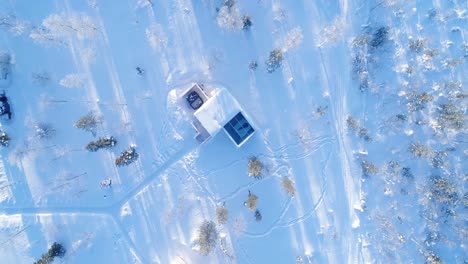 A-Bird'Seyeview-Zooms-Out-From-A-Man-Resting-In-Bed-At-The-Northern-Lights-Ranch-Revealing-The-Snowy-Landscape-That-Surrounds-His-Lodgings-1