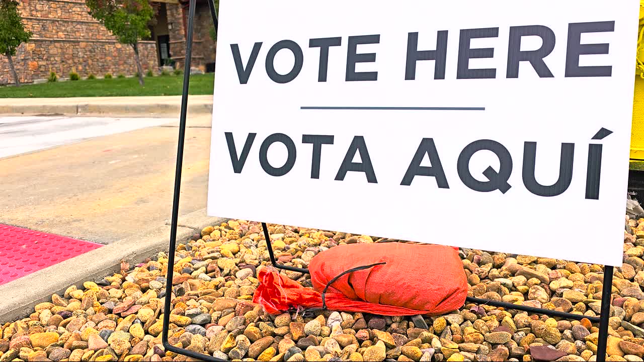 Vote Here Vota Aquí sign framed tightly in close-up to emphasize bilingual accessibility. Useful for campaign materials, election coverage, and visuals symbolizing democratic inclusion