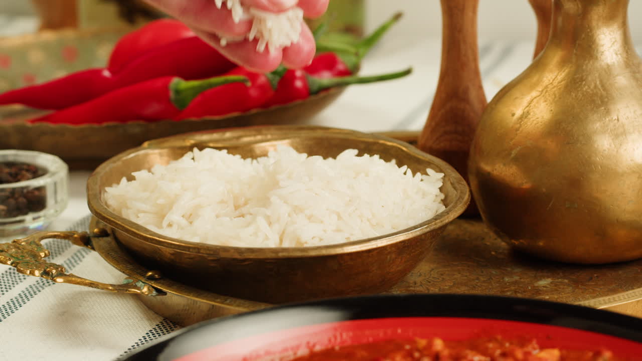 Assorted indian sri-lanka food set on wooden background. Dishes and appetisers of indeed cuisine, rice, lentils, paneer, samosa, spices, masala. Bowls and plates with indian food top view chicken. High quality 4k footage
