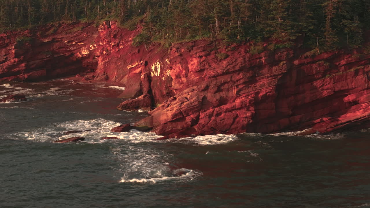 Aerial View of Red Cliffs and Ocean Waves
