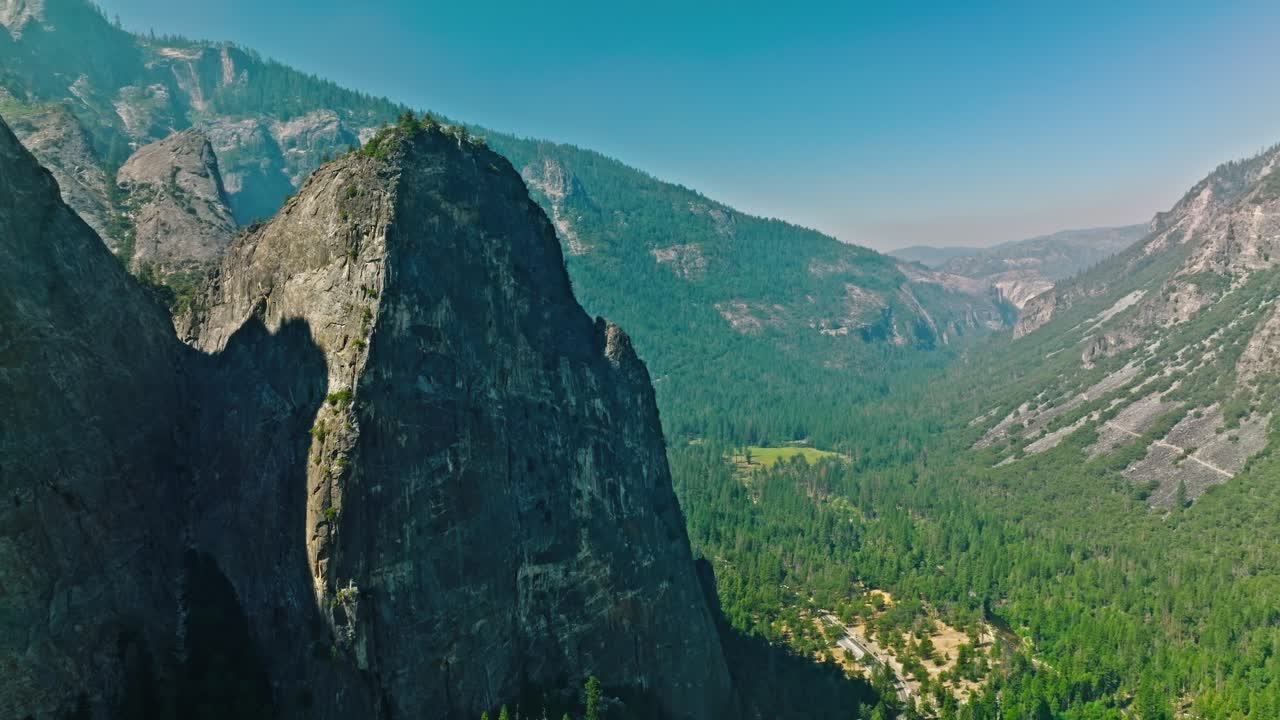 Forest on rocky mountain in Yosemite National Park at autumn sunny day