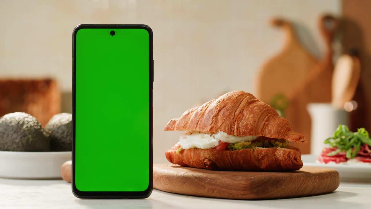 Green Screen Phone with Croissant Sandwich