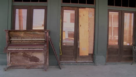 an old piano sits in front of a glaveston bar after hurricane ike 1