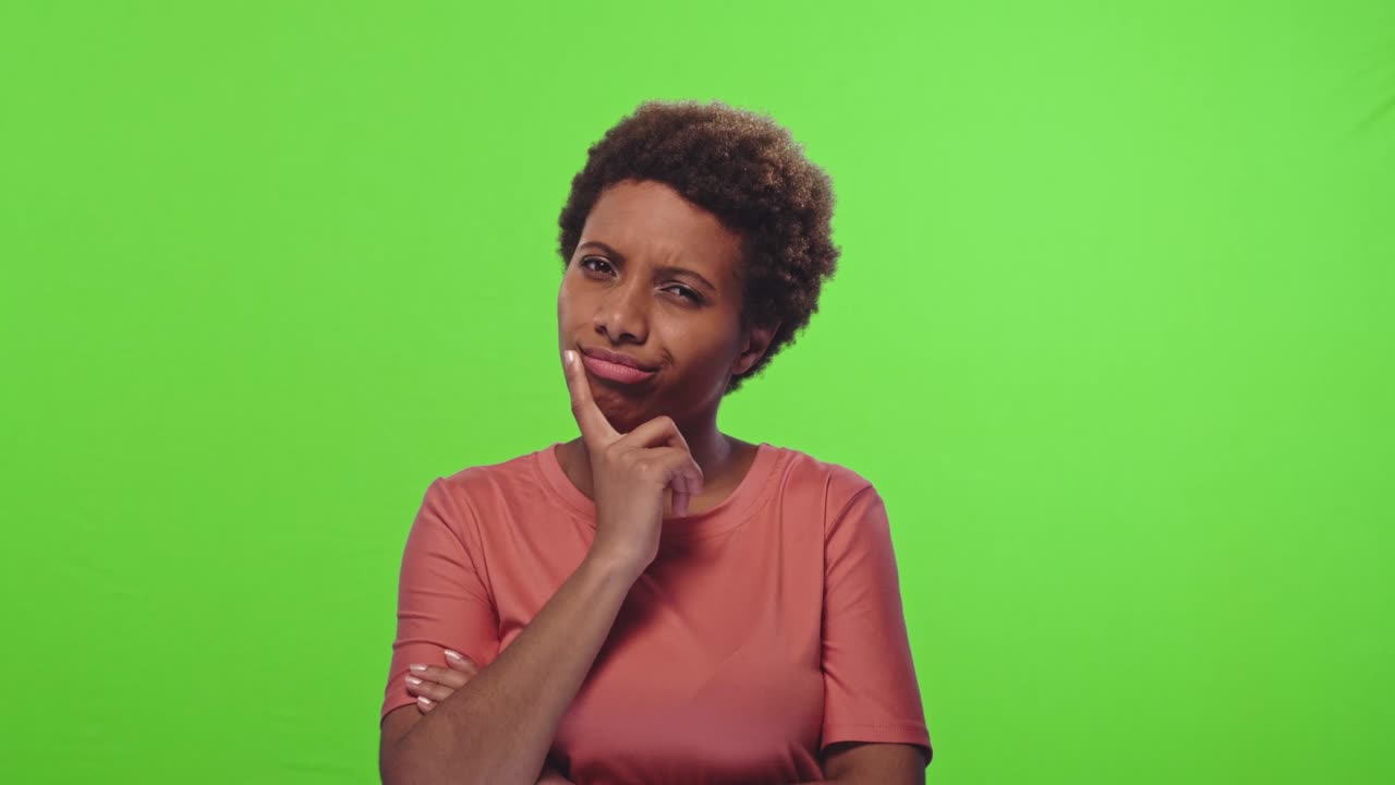 Pensive attractive curly African American female being deep in thoughts