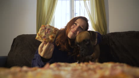woman and dog enjoying pizza