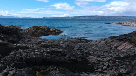 push-in drone shot of rocky beach shore