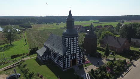 old historic half timbered catholic church in village aerial circulating