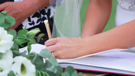 bride signing marriage license or wedding contract - high angle, close up