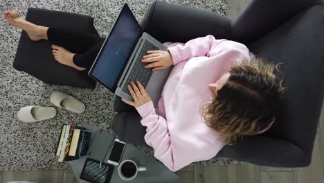 work-from-home freelancer working on comfortable armchair with computer