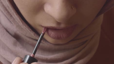 woman applying lipstick