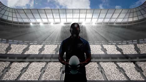 Animation-of-rugby-player-holding-ball-over-sports-stadium