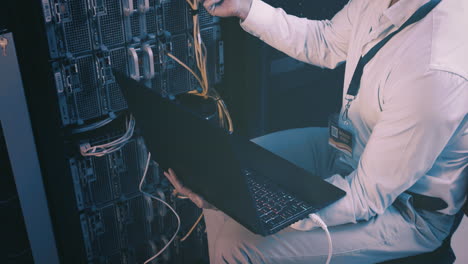 an unrecognisable man using a laptop while working