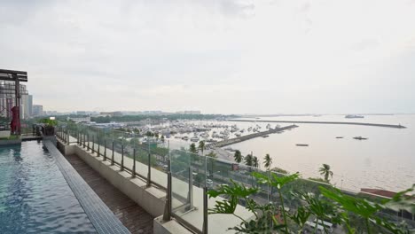 stunning rooftop pool overlooks the ocean, with yacht docks nearby, blending luxury and breathtaking coastal views.