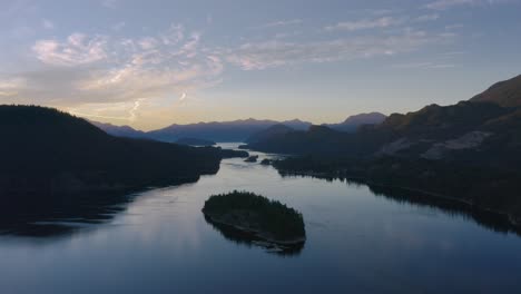 misty river and mountains of canada during sunset - aerial